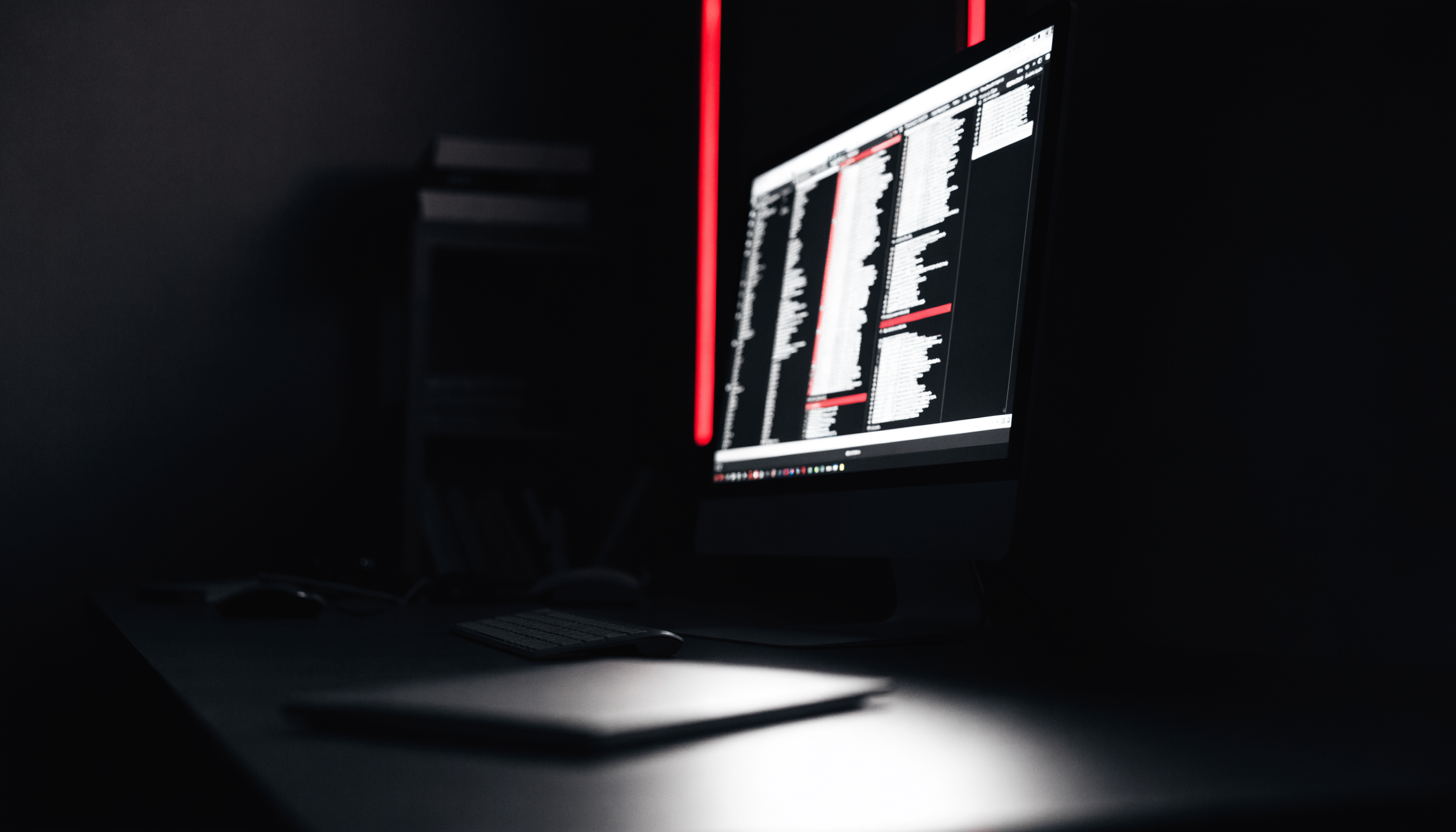 Dark studio workspace lit by a red-accented interface